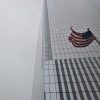 A U.S. flag near a skyscraper.
