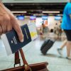 A person with a passport apparently in an airport.