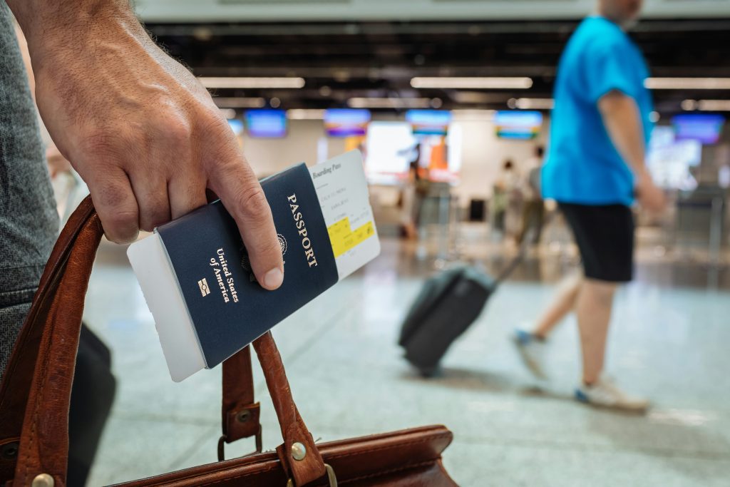 A person with a passport apparently in an airport.