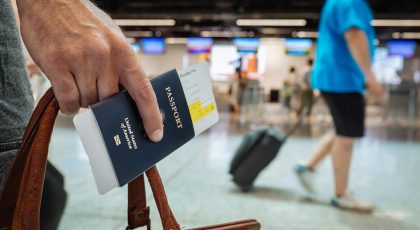 A person with a passport apparently in an airport.