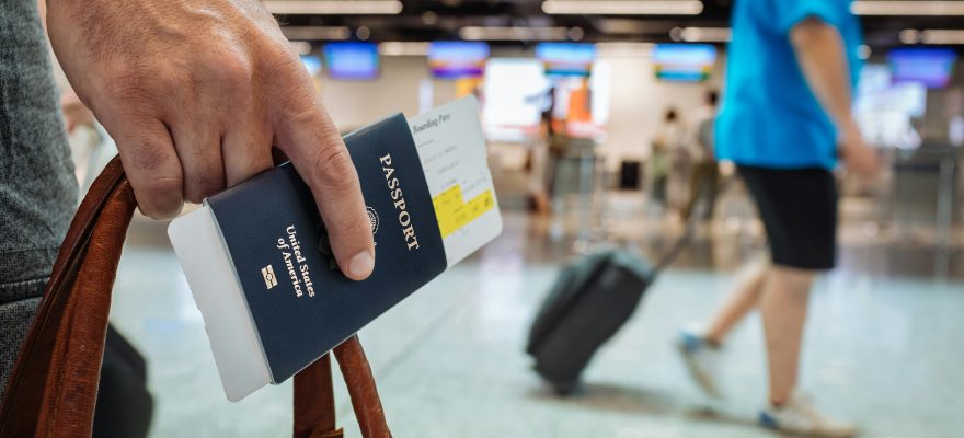 A person with a passport apparently in an airport.