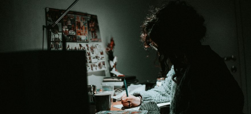 A person is on her computer, working.