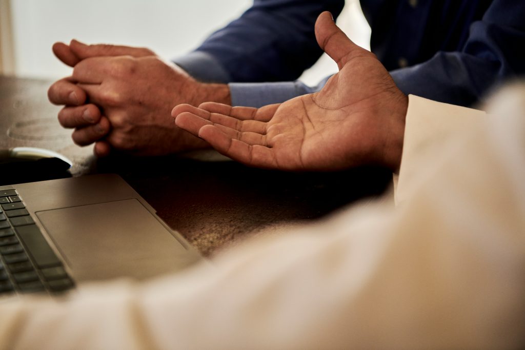 Two people seem to be talking with only their hands shown