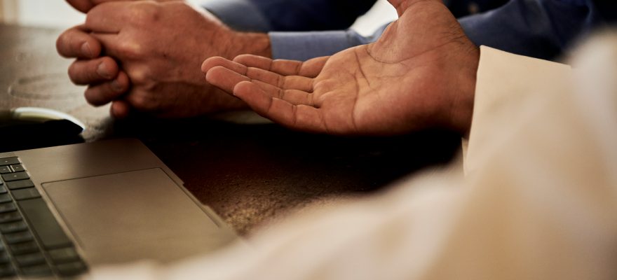 Two people seem to be talking with only their hands shown