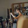 A person painting on a canvas.