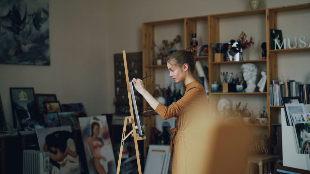 A person painting on a canvas.