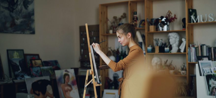 A person painting on a canvas.