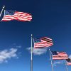 A series of U.S. flags seen from below.