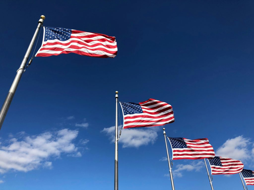 A series of U.S. flags seen from below.