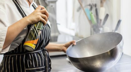 A chef with a large bowl in her hands.